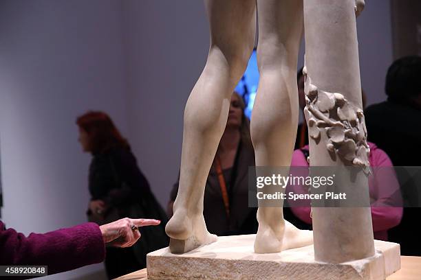 Visitors look at the marble statue named Adam, created in the 1490s by Italian Renaissance artist Tullio Lombardo, stands on display at the...