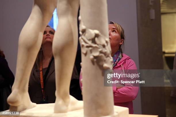 Visitors look up at the marble statue named Adam, created in the 1490s by Italian Renaissance artist Tullio Lombardo, at the Metropolitan Museum of...