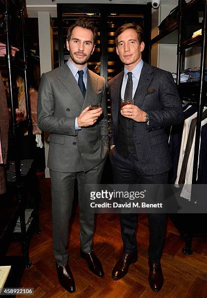 Designers Luke Sweeney and Thom Whiddett attend the opening of their new Thom Sweeney RTW & MTM Store on November 13, 2014 in London, England.