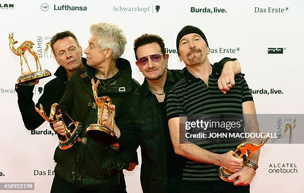 Irish singer-songwriter Bono and members of his band U2 pose with their trophies they were given in the category "Music International" during the...