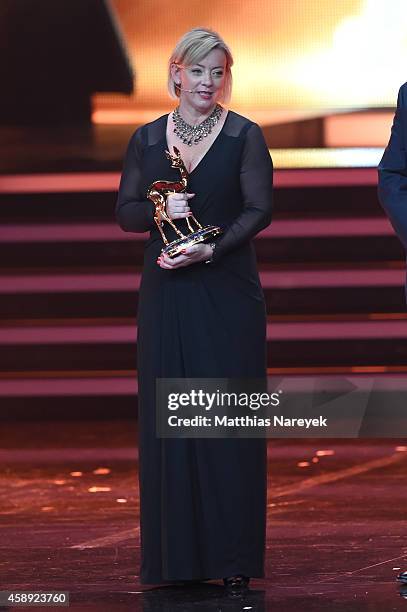 Sabine Kehm, managerin of Michael Schumacher, accepts the award on behalf of Michael Schumacher during the Bambi Awards 2014 show on November 13,...