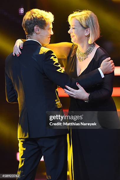 Sabine Kehm, managerin of Michael Schumacher, accepts the award on behalf of Michael Schumacher from Sebastian Vettel during the Bambi Awards 2014...