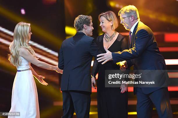 Sabine Kehm , managerin of Michael Schumacher, accepts the award on behalf of Michael Schumacher next to Formula 1 personality Ross Brawn from...