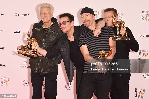 The members of the band U2, Adam Clayton, Bono, The Edge and Larry Mullen junior, pose with their award during Kryolan at the Bambi Awards 2014 on...