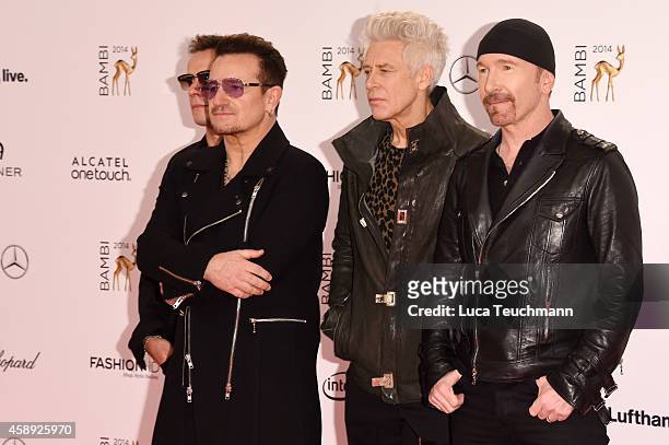 The members of the band U2, Adam Clayton, Bono, The Edge and Larry Mullen junior, pose with their award during Kryolan at the Bambi Awards 2014 on...