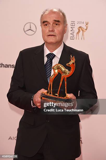 Wolfgang Sell, winner in the category 'Stille Helden' poses with his award during Kryolan at the Bambi Awards 2014 on November 13, 2014 in Berlin,...