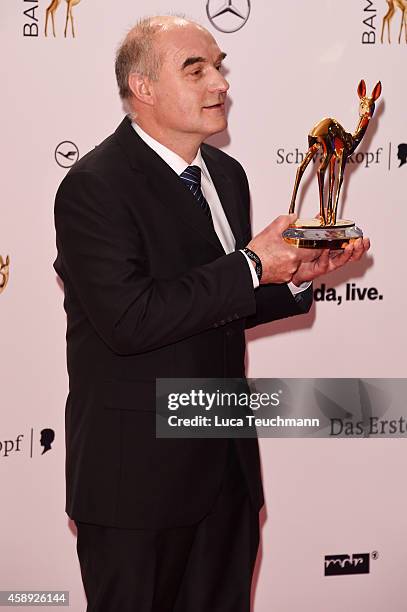 Wolfgang Sell, winner in the category 'Stille Helden' poses with his award during Kryolan at the Bambi Awards 2014 on November 13, 2014 in Berlin,...