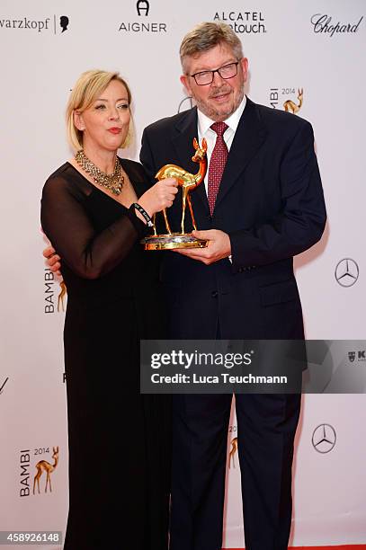 Sabine Kehm, managerin of Michael Schumacher, and Formula 1 personality Ross Brawn pose with the award of Michael Schumacher during Kryolan at the...