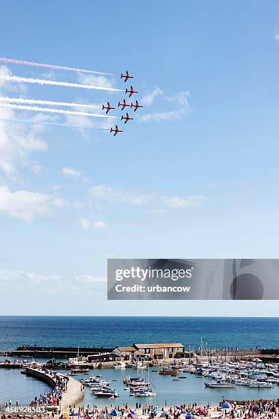 the red arrows above lyme regis - big fighters big cause stock pictures, royalty-free photos & images