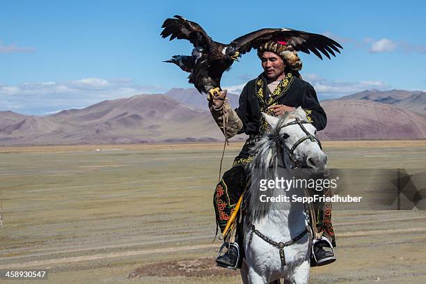mongolian eagle hunter riding - kazakhstan steppe stock pictures, royalty-free photos & images