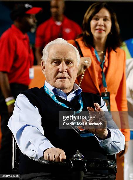 Former Miami Dolphins head coach Don Shula waves to a fan with his wife Mary Anne on the field before the Dolphins met the Buffalo Bills in a game at...