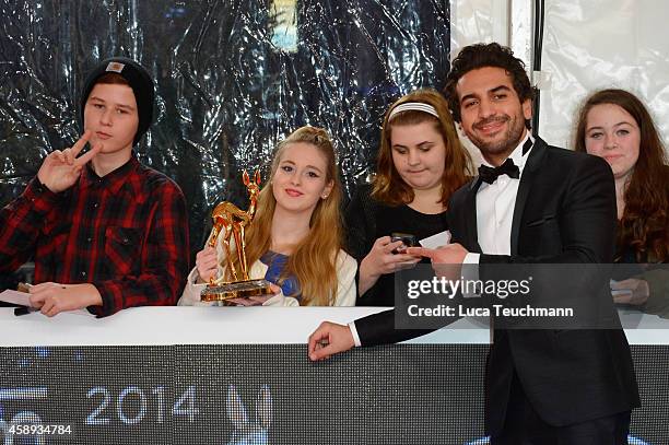 Elyas M'Barek poses with fans and his award during Kryolan at the Bambi Awards 2014 on November 13, 2014 in Berlin, Germany.