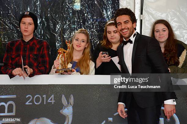 Elyas M'Barek poses with fans and his award during Kryolan at the Bambi Awards 2014 on November 13, 2014 in Berlin, Germany.