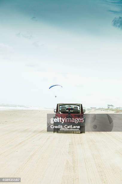 driving across carova beach in north carolina - motor paraglider stock pictures, royalty-free photos & images