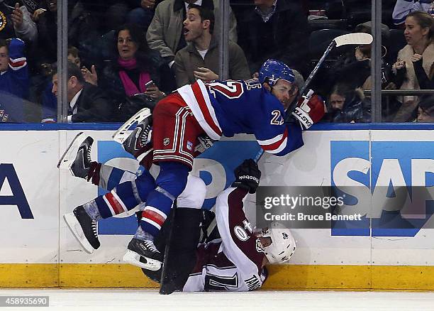 Dan Boyle of the New York Rangers hits Alex Tanguay of the Colorado Avalanche in overtime at Madison Square Garden on November 13, 2014 in New York...