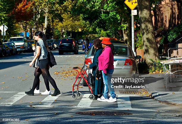 elderly woman crosses street, fort greene brooklyn, new york city - fort greene stock pictures, royalty-free photos & images