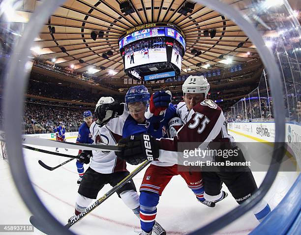 Maxime Talbot and Cody McLeod of the Colorado Avalanche combine to hit Jesper Fast of the New York Rangers at Madison Square Garden on November 13,...