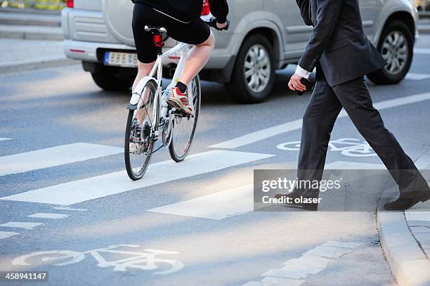 business man crossing street in traffic - pedestrian stock pictures, royalty-free photos & images