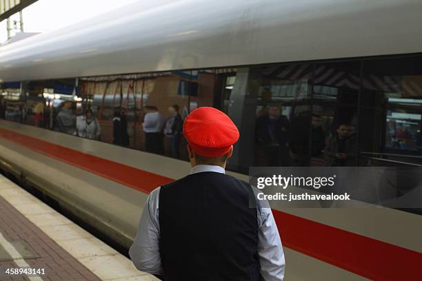 employee of deutsche bahn and passing ice - railroad conductor stock pictures, royalty-free photos & images