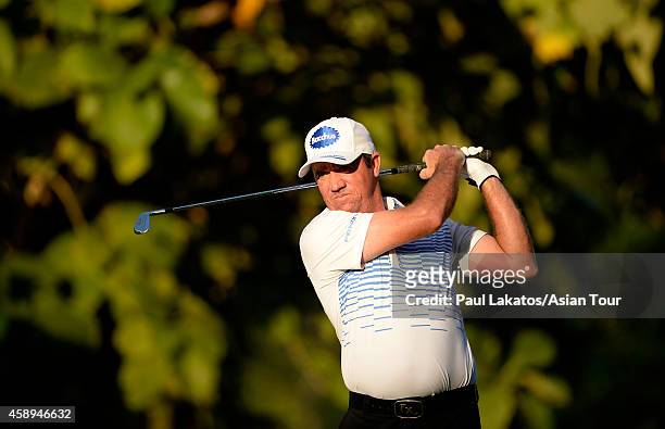Scott Hend of Australia plays a shot during round two of the Chiangmai Golf Classic at Alpine Golf Resort-Chiangmai on November 14, 2014 in Chiang...