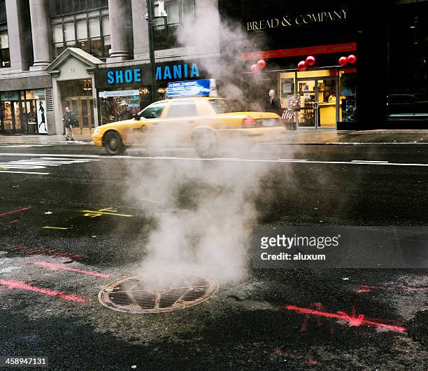steam coming out from manhole in new york - manhole stock pictures, royalty-free photos & images