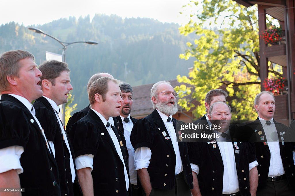 Swiss male yodel choir show facial expressions at agricultural festival