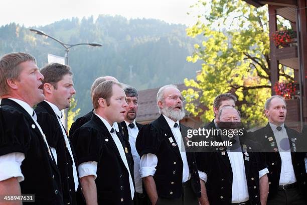 swiss male yodel choir show facial expressions at agricultural festival - yodeling stock pictures, royalty-free photos & images