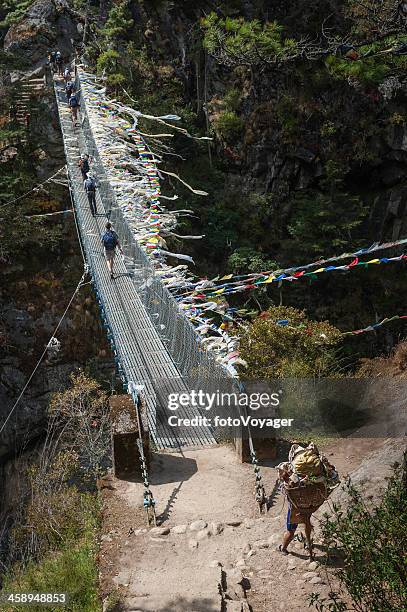 trekking across rope bridge in himalayas nepal - namche bazaar stock pictures, royalty-free photos & images