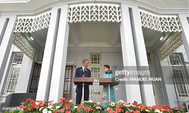 President Barack Obama and Myanmar's opposition leader Aung San Suu Kyi take part in a press conference at her residence in Yangon on November 14,...