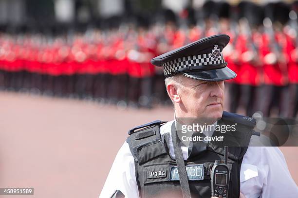 policeman and queens guards - british culture walking stock pictures, royalty-free photos & images