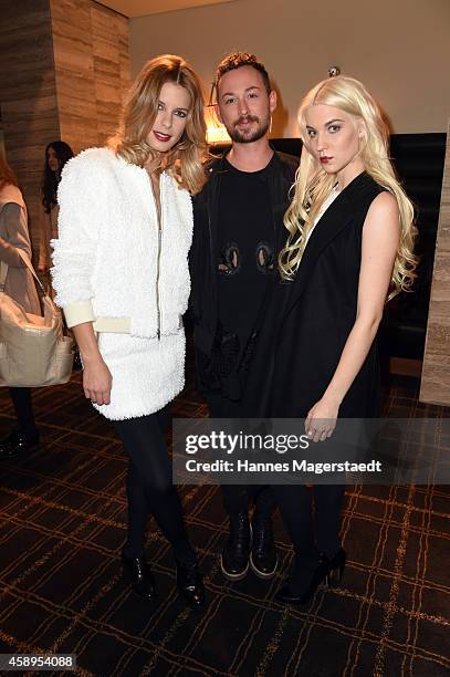 Marcel Ostertag, Julia Trainer and a model pose at the Marcel Ostertag Charity Fashion Show at Sofitel Munich Bayerpost on November 13, 2014 in...