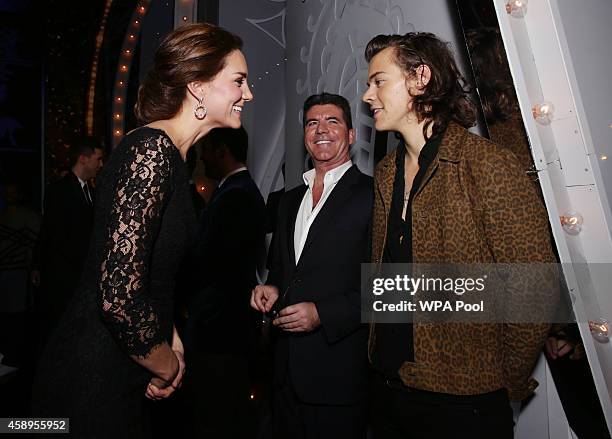 Catherine, Duchess of Cambridge meets Harry Styles of One Direction as Simon Cowell looks on at the end of The Royal Variety Performance at the...