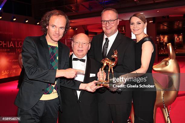 Cast members of the tv show 'heute show', Olaf Schubert, Hans-Joachim Heist, Oliver Welke and Martina Hill pose with their award during Kryolan at...