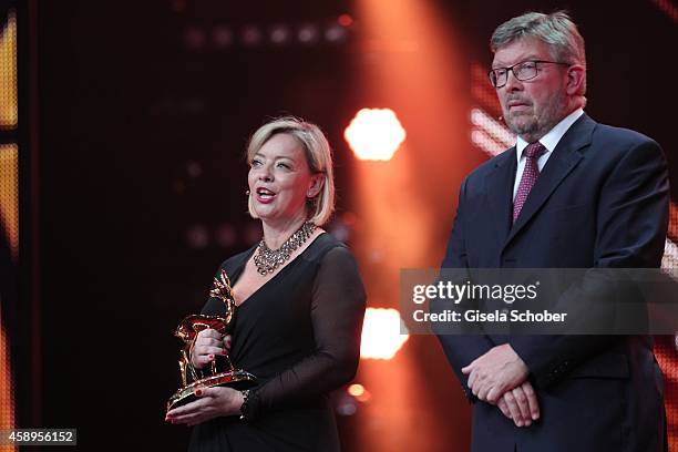 Sabine Kehm and Ross Brawn accept the millennium award on behalf of Michael Schumacher during the Bambi Awards 2014 show on November 13, 2014 in...