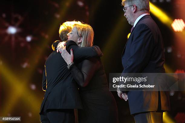 Sebastian Vettel, Sabine Kehm and Ross Brawn are seen on stage during the Bambi Awards 2014 show on November 13, 2014 in Berlin, Germany.