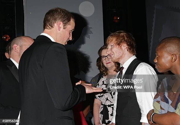 Prince William, Duke of Cambridge meets Ed Sheeran as Sarah Millican looks on at the end of The Royal Variety Performance at the London Palladium on...