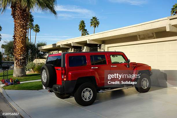 red suv parked on residential driveway - hummer h3 stock pictures, royalty-free photos & images