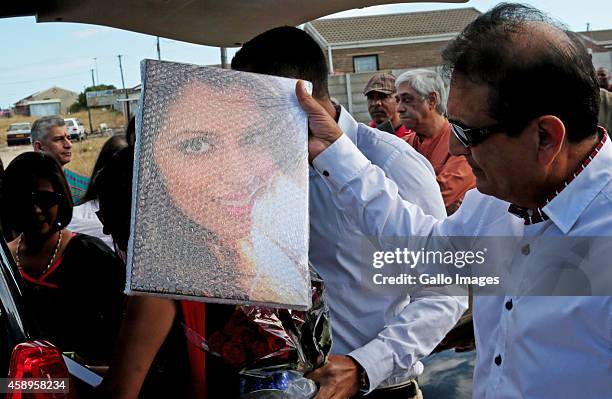 Anni Dewani's father Vinod Hindocha holds a photo of his daughter as the family marks the fourth anniversary of her death on November 13, 2014 in...