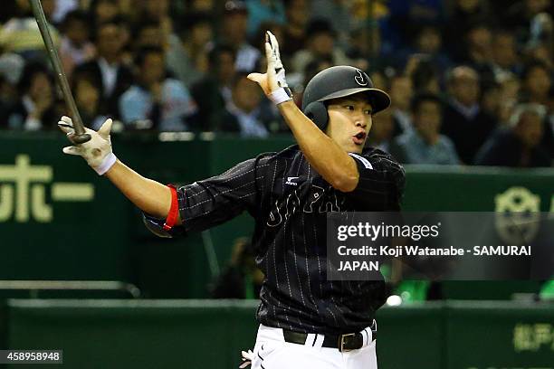 Yuki Yanagita of Samurai Japan hits to the right field sending one runner home in the fourth inning during the game two of Samurai Japan and MLB All...