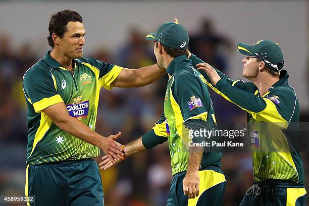 Nathan Coulter-Nile celebrates with Glenn Maxwell and Steve Smith after the dismissal of Dale Steyn of South Africa during game one of the men's one...
