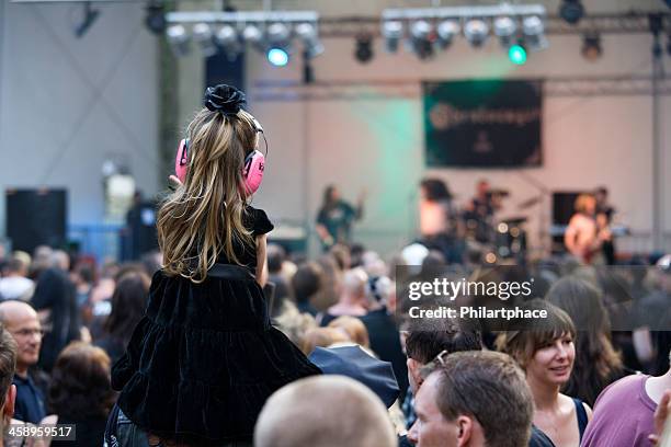 little girl with ear protection on concert - ear protection stock pictures, royalty-free photos & images