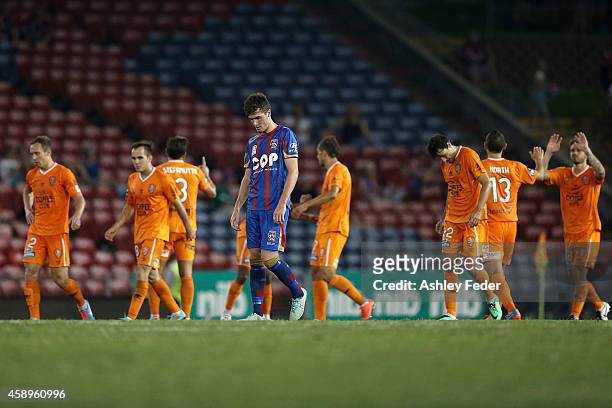 Allan Welsh of the Jets looks dejected after losing with Roar celebrating in the background during the round six A-League match between the Newcastle...