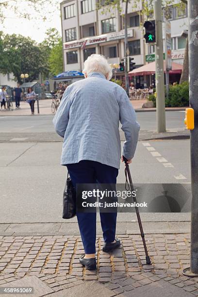 crossing street - elderly woman from behind stock pictures, royalty-free photos & images