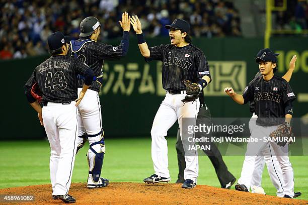 Catcher Hikaru Ito and pitcher Tomomi Takahashi of Samurai Japan celebrate after winning the game two of Samurai Japan and MLB All Stars at Tokyo...