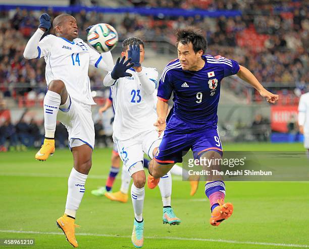 Shinji Okazaki of Japan and Oscar Boniek Garcia of Honduras compete for the ball during the international friendly match between Japan and Honduras...