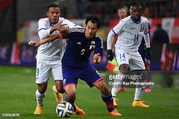 Shinji Okazaki of Japan beats Luis Garrido of Honduras during the international friendly match between Japan and Honduras at Toyota Stadium on...