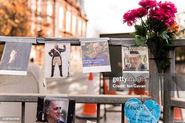 General view of photographs and messages of condolences on the traffic island as a memorial bench for the late Rik Mayall is unveiled on November 14,...