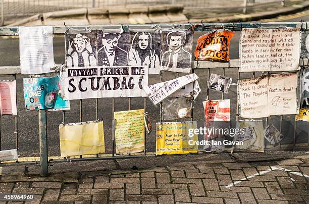 General view of photographs and messages of condolences on the traffic island as a memorial bench for the late Rik Mayall is unveiled on November 14,...