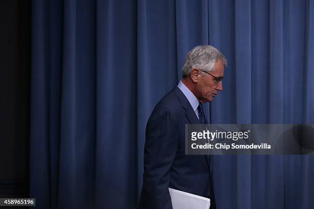 Defense Secretary Chuck Hagel arrives for a news conference before announcing a series of reforms to the troubled nuclear force at the Pentagon...