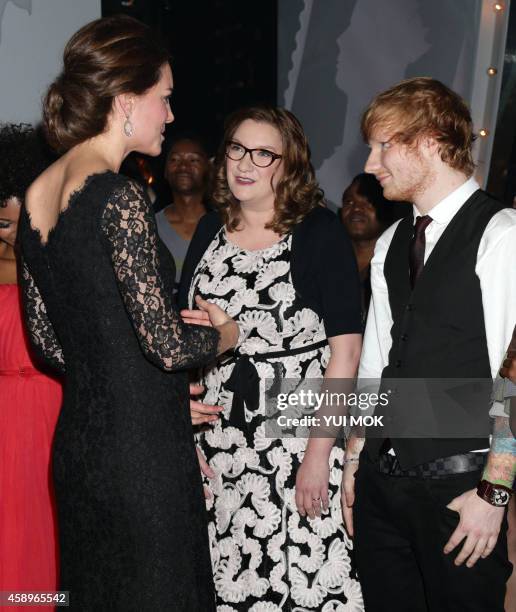 Catherine, Duchess of Cambridge meets British comedian Sarah Millican and British singer Ed Sheeran following the Royal Variety Performance at the...
